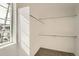 Walk-in closet with carpet and white shelving offering ample storage, complemented by natural light through a window at 2058 S Haleyville Way, Aurora, CO 80018