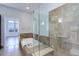 Bright bathroom featuring tile surround glass enclosed walk-in shower and soaking tub at 5455 Landmark Pl # 407, Greenwood Village, CO 80111