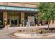 Beautiful entrance to The Landmark West, featuring a fountain, flowers, and manicured trees at 5455 Landmark Pl # 407, Greenwood Village, CO 80111
