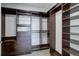 Custom walk-in closet with dark wood shelving, drawers, and a built-in safe at 5455 Landmark Pl # 407, Greenwood Village, CO 80111