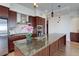 Well-equipped kitchen featuring a granite island, stainless steel appliances, and pendant lighting at 5455 Landmark Pl # 407, Greenwood Village, CO 80111