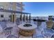 Inviting outdoor patio with stone fire pit, mountain views, and pergola; perfect for entertaining and relaxation at 5455 Landmark Pl # 407, Greenwood Village, CO 80111