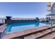 Stunning pool area with waterfall features, mountain views, glass safety fence and comfortable lounge seating at 5455 Landmark Pl # 407, Greenwood Village, CO 80111