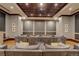 Cozy theater room featuring tiered seating, projector, and wood-paneled ceiling for an immersive entertainment experience at 5455 Landmark Pl # 407, Greenwood Village, CO 80111