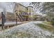 Two-story home featuring a backyard with an upper and lower wood patio at 822 Shadowstone Dr, Highlands Ranch, CO 80129