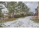 Spacious backyard with lush green grass and mature trees at 822 Shadowstone Dr, Highlands Ranch, CO 80129