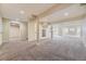 Open basement space with neutral carpet, recessed lighting, and large support pillars at 822 Shadowstone Dr, Highlands Ranch, CO 80129