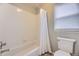 Clean bathroom with a white tiled shower-tub combination at 822 Shadowstone Dr, Highlands Ranch, CO 80129