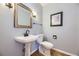 Bathroom features include a pedestal sink, and wood look flooring at 822 Shadowstone Dr, Highlands Ranch, CO 80129
