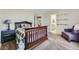 Spacious bedroom with cozy carpeting, a dark wood bed frame and a connecting bathroom at 822 Shadowstone Dr, Highlands Ranch, CO 80129
