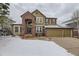 Charming two-story home featuring a brick and siding exterior at 822 Shadowstone Dr, Highlands Ranch, CO 80129