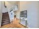 Bright foyer with a staircase, hardwood floors, and a stylish console table at 822 Shadowstone Dr, Highlands Ranch, CO 80129
