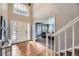 Bright foyer features hardwood floors, high ceilings, and a view into the living room at 822 Shadowstone Dr, Highlands Ranch, CO 80129