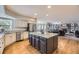 Bright kitchen boasts hardwood floors, white cabinets, stainless appliances and a granite island at 822 Shadowstone Dr, Highlands Ranch, CO 80129