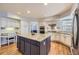 Spacious kitchen features a large island with granite countertops and custom white cabinets at 822 Shadowstone Dr, Highlands Ranch, CO 80129