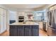 Kitchen features include an island with granite countertops and stainless steel appliances at 822 Shadowstone Dr, Highlands Ranch, CO 80129