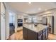 Bright kitchen boasts hardwood floors, white cabinets, stainless appliances and a granite island at 822 Shadowstone Dr, Highlands Ranch, CO 80129
