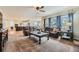 Spacious living room showcasing an open floor plan to the kitchen with comfortable furniture and natural light at 822 Shadowstone Dr, Highlands Ranch, CO 80129