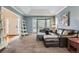 Bright living room with blue walls, carpet, and a bay window that provides natural light at 822 Shadowstone Dr, Highlands Ranch, CO 80129