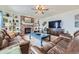 Comfortable living room featuring a brick fireplace, built-in shelves, and plush leather furniture at 822 Shadowstone Dr, Highlands Ranch, CO 80129