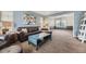 Cozy living room with carpet, leather furniture, and an accent wall at 822 Shadowstone Dr, Highlands Ranch, CO 80129