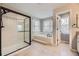 Spacious main bathroom featuring a walk-in shower, soaker tub, and natural light. Perfect for a spa-like experience at 822 Shadowstone Dr, Highlands Ranch, CO 80129