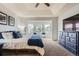 Beautiful main bedroom featuring a sitting area, tray ceiling, and large windows, providing ample natural light and comfort at 822 Shadowstone Dr, Highlands Ranch, CO 80129