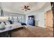 Spacious main bedroom featuring a tray ceiling, a large bay window, and dark furnishings, creating a luxurious living space at 822 Shadowstone Dr, Highlands Ranch, CO 80129
