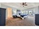 Bright main bedroom with a ceiling fan, bay windows, and stylish blue and white decor, creating a peaceful retreat at 822 Shadowstone Dr, Highlands Ranch, CO 80129