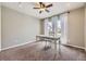 Home office with carpet, a ceiling fan, and natural light from the large window at 822 Shadowstone Dr, Highlands Ranch, CO 80129