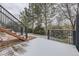 Wood patio area featuring steps down to the yard with black metal railings at 822 Shadowstone Dr, Highlands Ranch, CO 80129