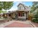 Charming home exterior with a covered front porch, brick walkway, and tidy landscaping at 3440 W 33Rd Ave, Denver, CO 80211