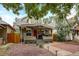 Charming home with a covered front porch, landscaped yard, and a welcoming red front door at 3440 W 33Rd Ave, Denver, CO 80211