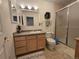 Well-lit bathroom with light wood vanity, shower, and neutral tile at 7290 S Cook Cir, Centennial, CO 80122