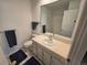 Bright bathroom with white vanity, large mirror, and blue accents at 7290 S Cook Cir, Centennial, CO 80122