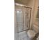 Bathroom with shower stall featuring a glass door and tile surround at 7290 S Cook Cir, Centennial, CO 80122