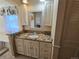 Bathroom features granite countertops, a decorative mirror, and custom cabinets at 7290 S Cook Cir, Centennial, CO 80122