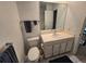 Simple bathroom featuring a white vanity, toilet, and large mirror at 7290 S Cook Cir, Centennial, CO 80122