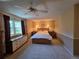 Comfortable bedroom with neutral carpet, wall lighting, and a large window at 7290 S Cook Cir, Centennial, CO 80122