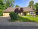 Inviting home exterior with well-manicured lawn, mature trees, and a two-car garage, providing classic curb appeal at 7290 S Cook Cir, Centennial, CO 80122