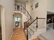 Bright foyer with hardwood floors and an elegant staircase with views to dining room at 7290 S Cook Cir, Centennial, CO 80122