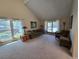 Sun-filled living room with vaulted ceiling, neutral carpet, and large windows at 7290 S Cook Cir, Centennial, CO 80122
