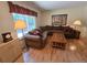 Comfortable living room features a large window, cozy seating, and wood accents at 7290 S Cook Cir, Centennial, CO 80122