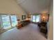 Bright living room with vaulted ceiling, cozy seating, and large windows at 7290 S Cook Cir, Centennial, CO 80122