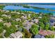Aerial view of residences near a lake surrounded by lush trees with easy access to the water and walking trails at 5350 S Marshall St, Littleton, CO 80123
