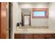 Bathroom features a glass door shower, a vanity with a mirror, and dark wood trim at 5350 S Marshall St, Littleton, CO 80123
