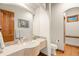 Bathroom with a toilet, wooden door, a large mirror, and a sink with stone countertops and brushed metal faucet at 5350 S Marshall St, Littleton, CO 80123