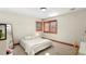 Bedroom with carpet flooring, light walls, a full-size bed, and window with wooden trim at 5350 S Marshall St, Littleton, CO 80123