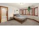 Bedroom with a full size bed, many windows, and access to a bathroom with a glass shower at 5350 S Marshall St, Littleton, CO 80123