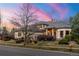 Charming home with well-manicured lawn, mature trees, and elegant brick and stone accents at 5350 S Marshall St, Littleton, CO 80123